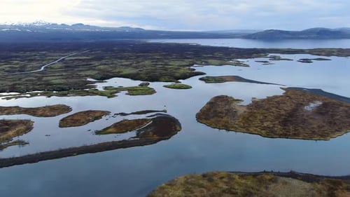 Stunning aerial shot of a lake, mountains and blue sky in Iceland