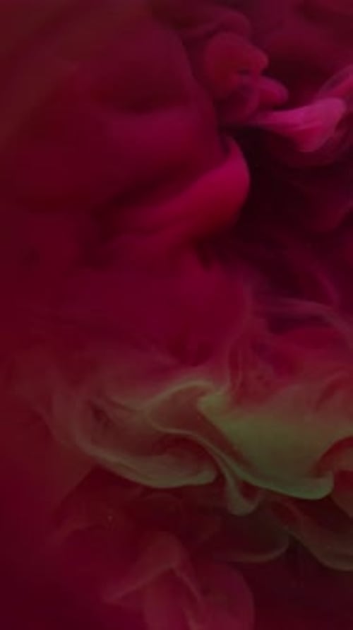 Swirling pink and green abstract clouds underwater