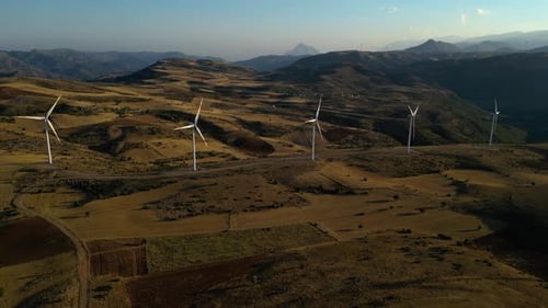 Wind Turbines Spinning on Rural Hillside Aerial View