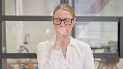 Portrait of Coughing Sick Mature Business Woman in Office