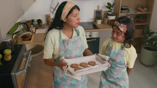Woman and Child Holding a Tray of Cookies