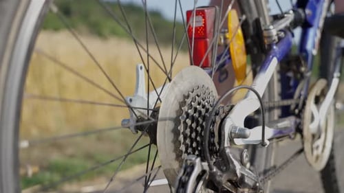 Detailed View of Someone Cycling on a Road Showcasing the Bicycle Wheel Tire