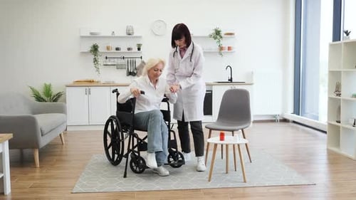 Doctor Helping Senior Woman Walk with Cane in Home