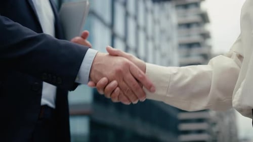 Two Business People Handshaking Meeting in City Businessman Handshake with Businesswoman Partners