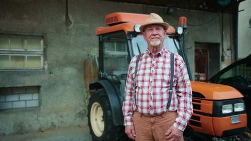 Portrait of Bearded Middleaged Man Looking at Camera in Farm Agricultural Worker Standing in Front