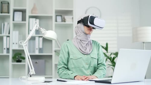 Woman Uses Virtual Reality Headset in Office