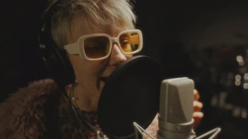 Expressive Female Musician Recording New Song in Professional Audio Studio