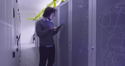 IT Professional Using Tablet in Server Room