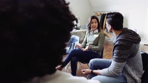 Support group shares stories in light modern room