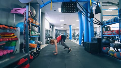 Woman exercising at fitness studio. Young beautiful girl wearing fashion sports wear doing exercise