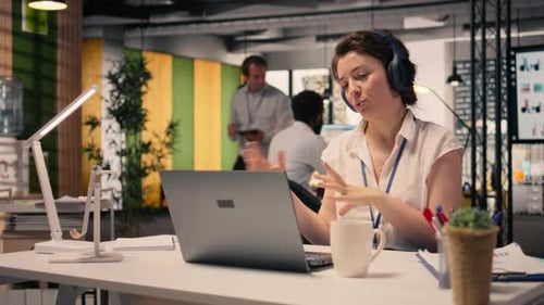 Business Woman Video Conferencing with Colleagues in Modern Office