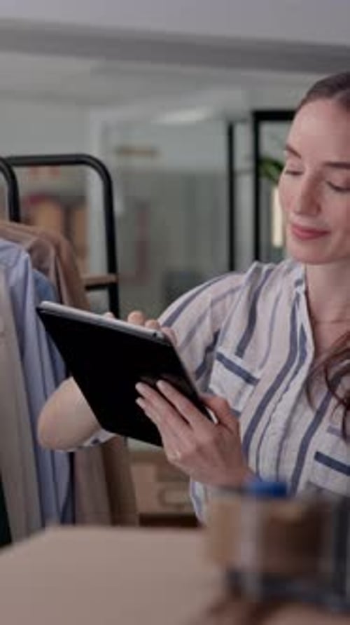 Woman Using Tablet in Clothing Store