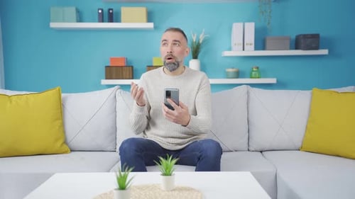 Man Shocked While Using Mobile Phone Indoors