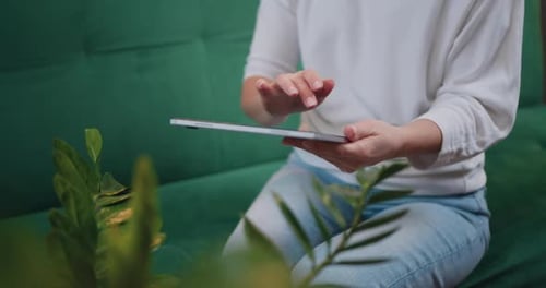 Woman Touching Screen of Digital Tablet, Hands of Close-up. Businesswoman Sitting on Couch.