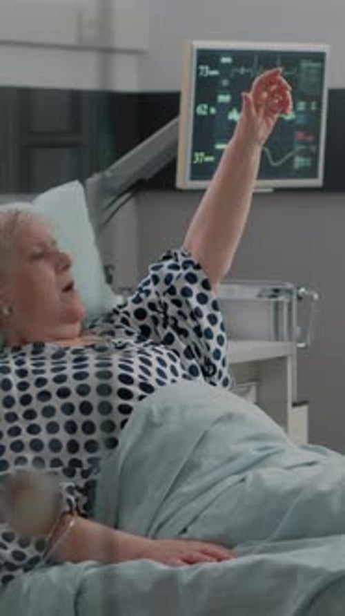 Senior Woman Receives Medical Care in Hospital Bed