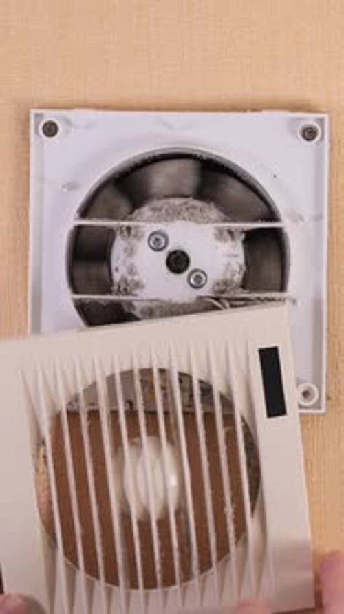 Vertical Video Technician Cleaning Dust From a Dirty Ventilation Grill