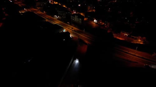 Aerial View of Cars Driving on City Streets at Night