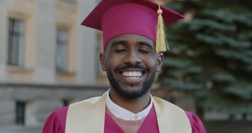 Slow Motion Portrait of Happy African American Student Graduating From University Smiling Outdoors