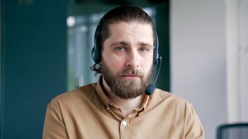 Webcam view. Confident businessman in headset talking on a video call looking at camera sitting