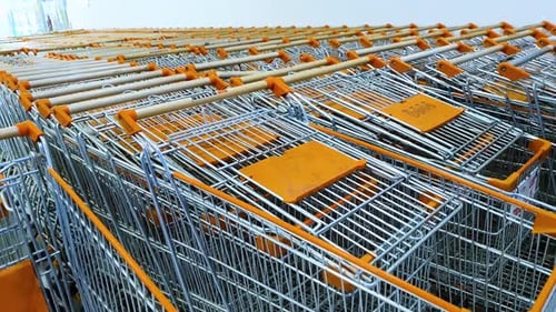 Panning shot of shopping trollies lying vacant at the shopping mall due to Covid.