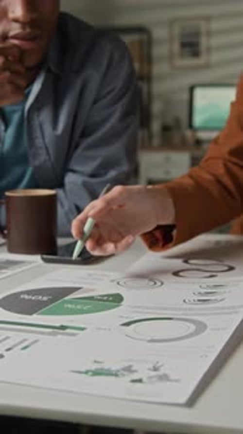 Office Team Analyzing Printed Chart Together