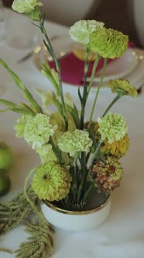 Floral centerpiece of green and cream flowers