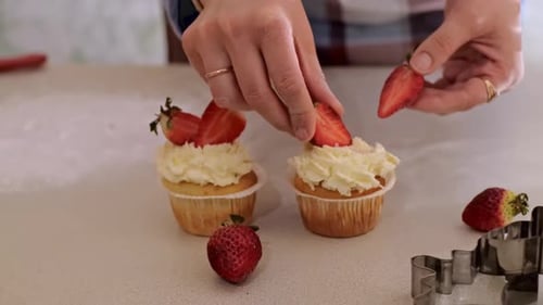 Decorating Cupcakes with Cream and Fresh Strawberries