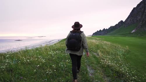 Traveler Girl Dressed in a Hat a Green Jacket and Backpack She Walks Along the Coast of the