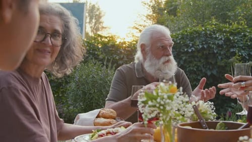 Family Togetherness at Outdoor Dinner at Sunset