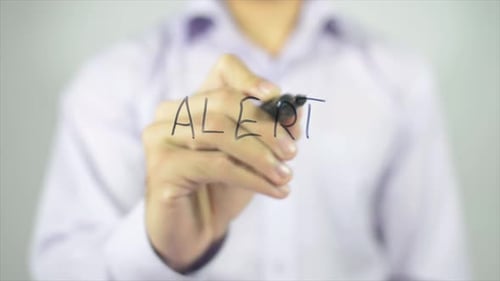 Man Writes Alert on Transparent Surface