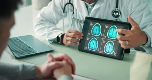 Doctor Showing Brain Scan to Patient on Tablet