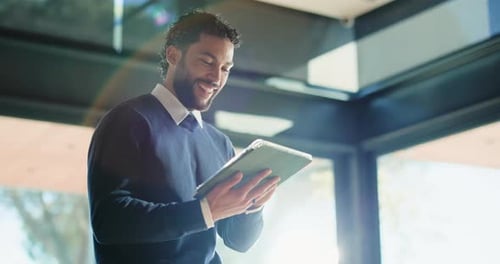 Business, man and smile with tablet in office for research, proofreading article and update draft