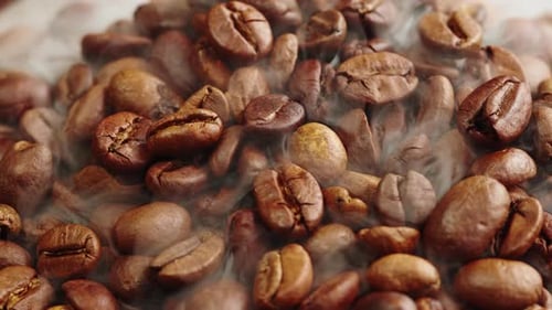 Roasting Coffee Beans with Smoke on Dark Background Close Up Arabica Robusta Colombian Beans