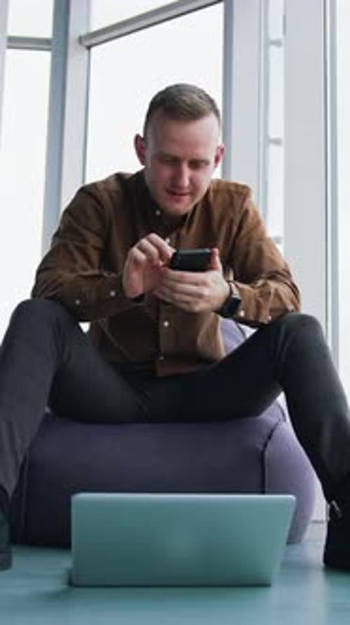 Young Adult Using Smartphone Indoors in an Urban Setting