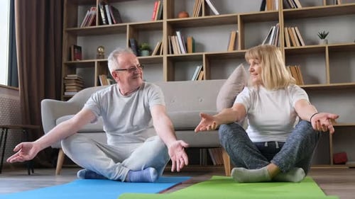 Senior Couple Practicing Yoga at Home for Wellness