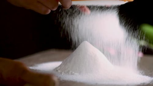 SIFTING WHEAT FLOUR BY SIEVE TO MAKE DOUGH ON KITCHEN, CHEF PREPARING RAW FOOD FOR COOKING