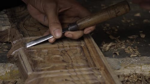 Craftsman Carving Intricate Wood Designs