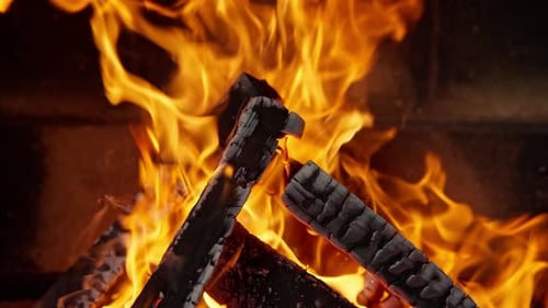 Burning Logs in a Cozy Fireplace at Night