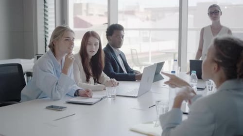 A Diverse Team of Professionals is Holding a Business Meeting in a Contemporary Office Environment