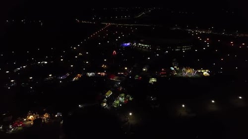 Aerial View of a City Event on a Square with a Concert and и and Rows of Tents Illuminated By Lights