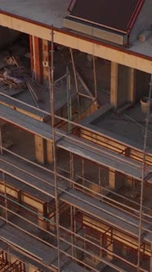 Vertical Video A Residential Project Under Construction with Visible Steel Frames Scaffolding and