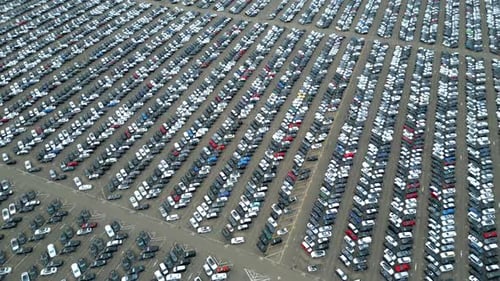 Many cars on a parking lot from above, filmed with a drone in 4k. high quality, thousand's of cars,