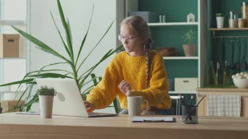 Girl Uses Laptop While Drinking in Home