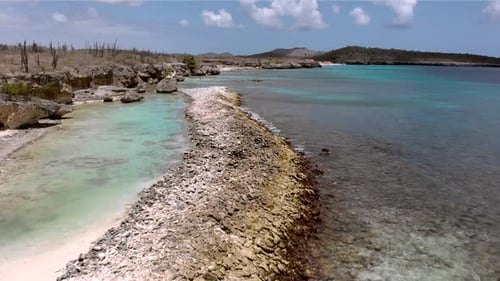Flying slowly over a paradisiac little turqoise water lagoon in a caribbean island.