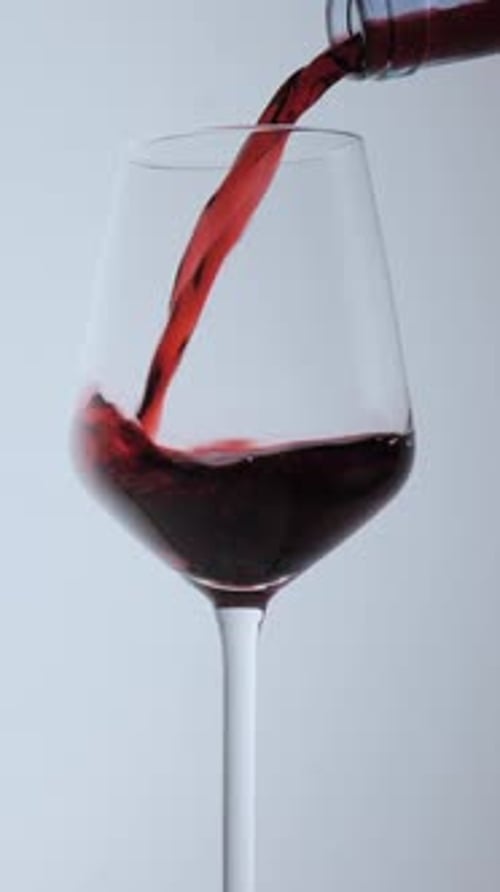 Pouring Red Wine into a Glass Close Up