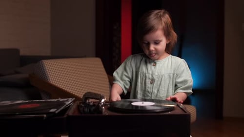 Child Plays Vintage Record Player at Home