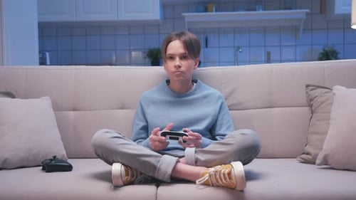 Young Adult Playing Video Games at Home