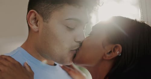 Romantic Couple Sharing a Gentle Kiss Indoors