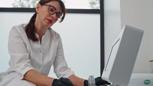 Medical Professional Using Advanced Device in Clinic