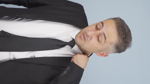 Vertical video of Businessman overwhelmed by the air temperature.